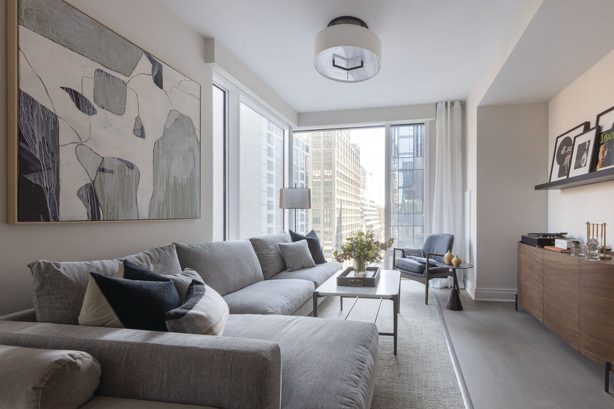 Coterie Hudson Yards apartment living room with floor to ceiling windows and modern furniture