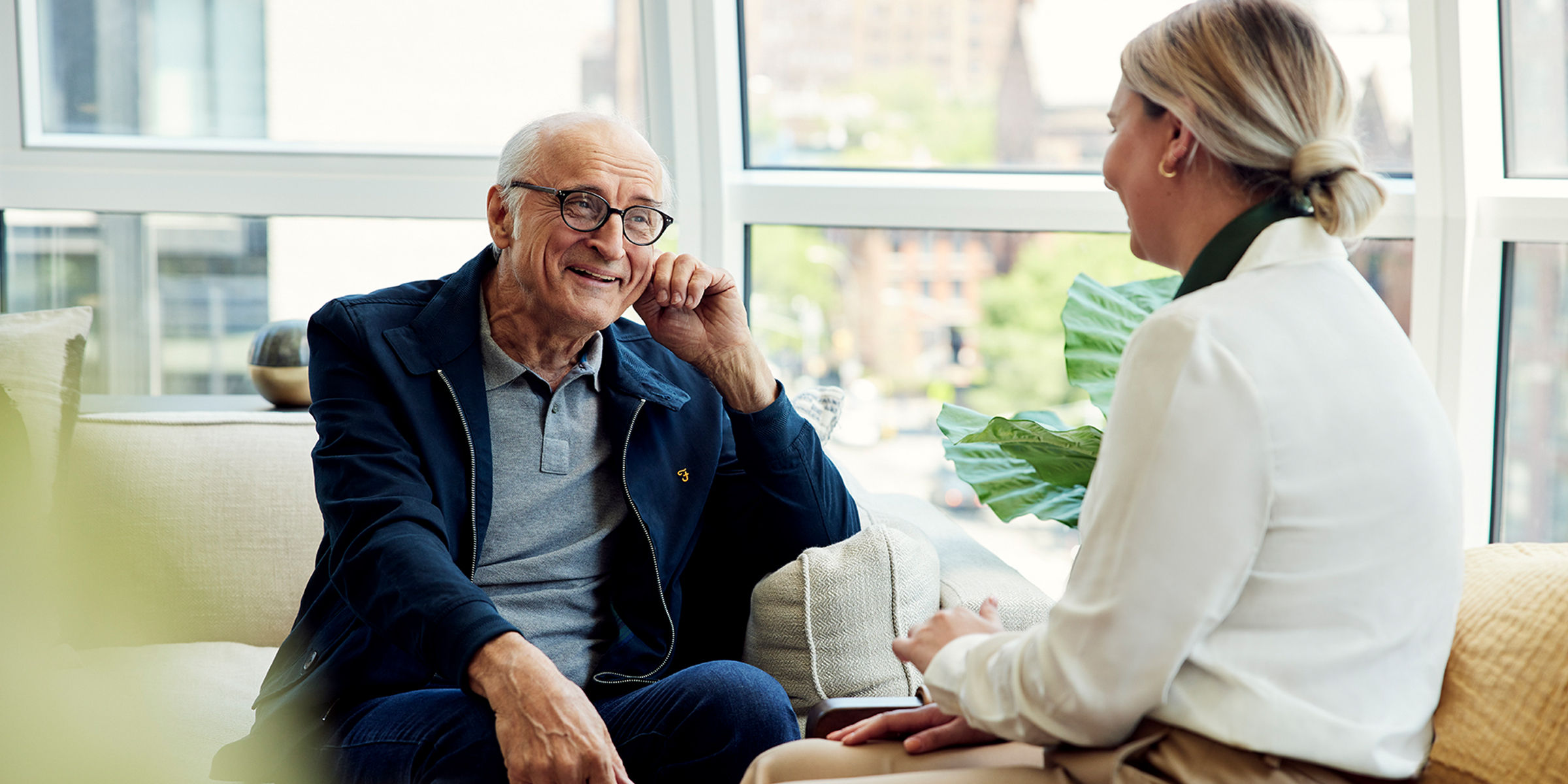 senior man speaking with a female care provider